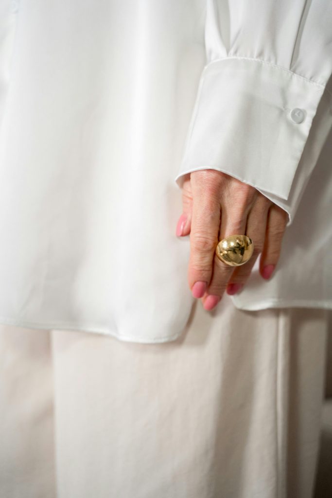 Close-up of a hand wearing a golden ring