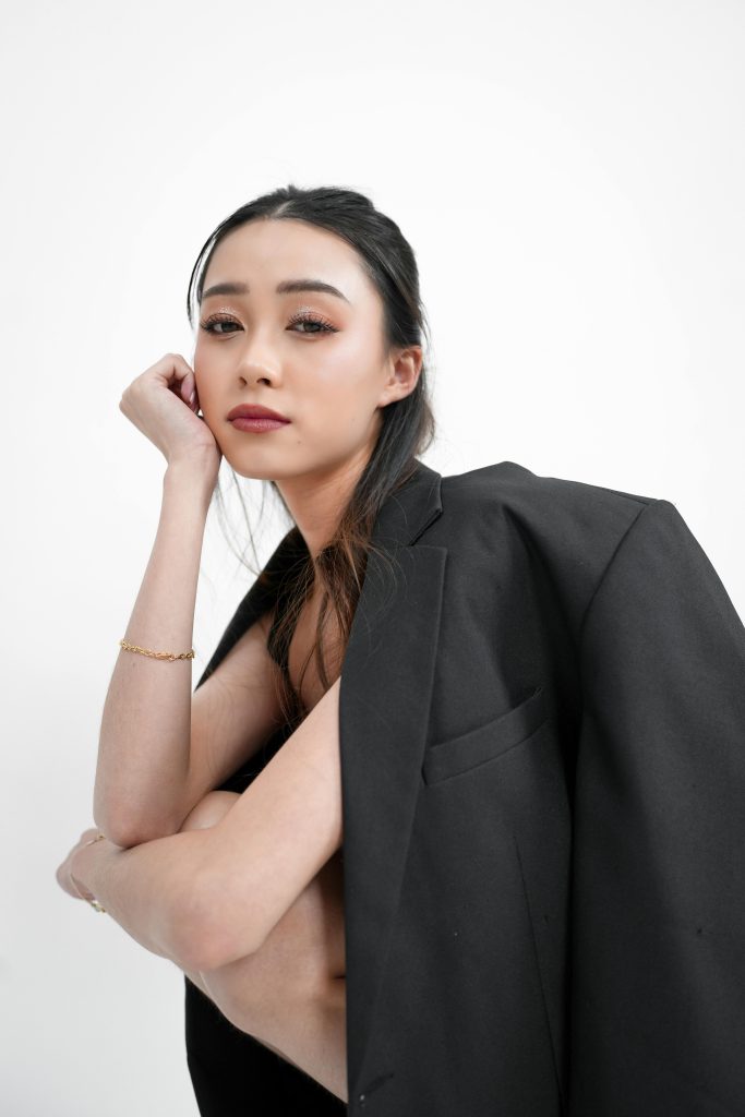 photo of a woman up-close wearing a black blazer.